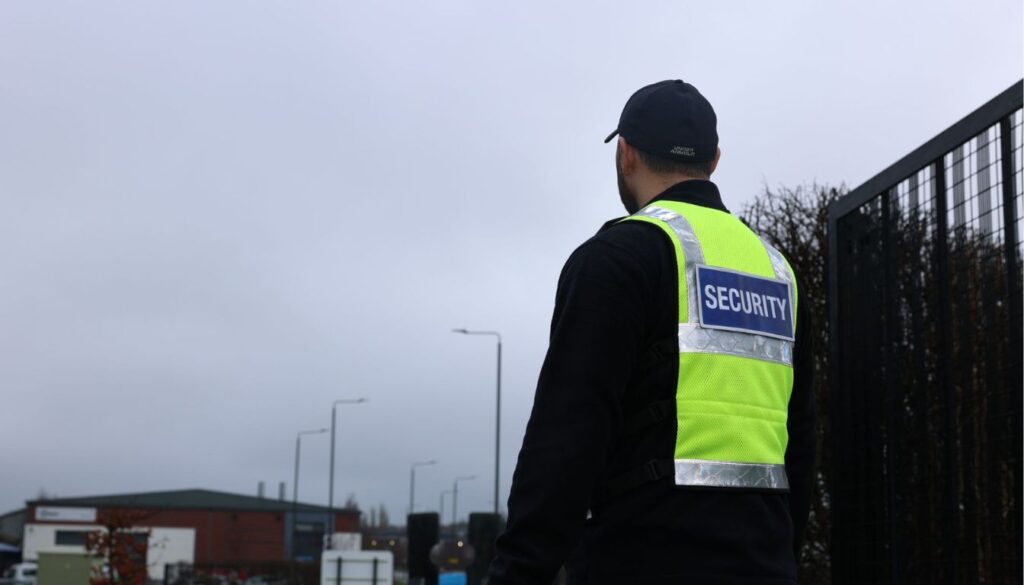 Close-up of a Proforce Security officer in branded uniform carrying out his duties and providing security guard services while monitoring activity on a construction site.